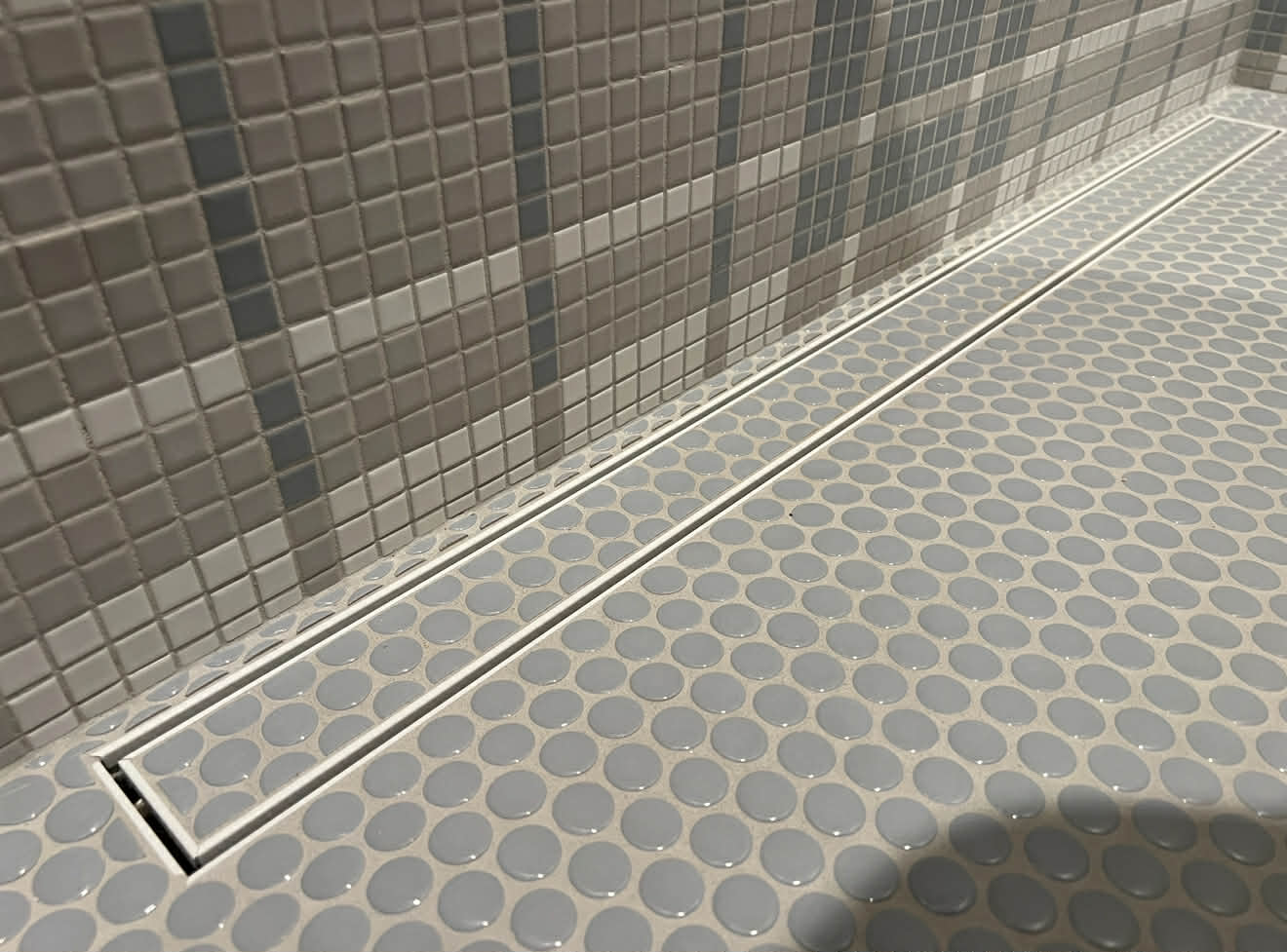 Shower floor with linear drain and penny tile