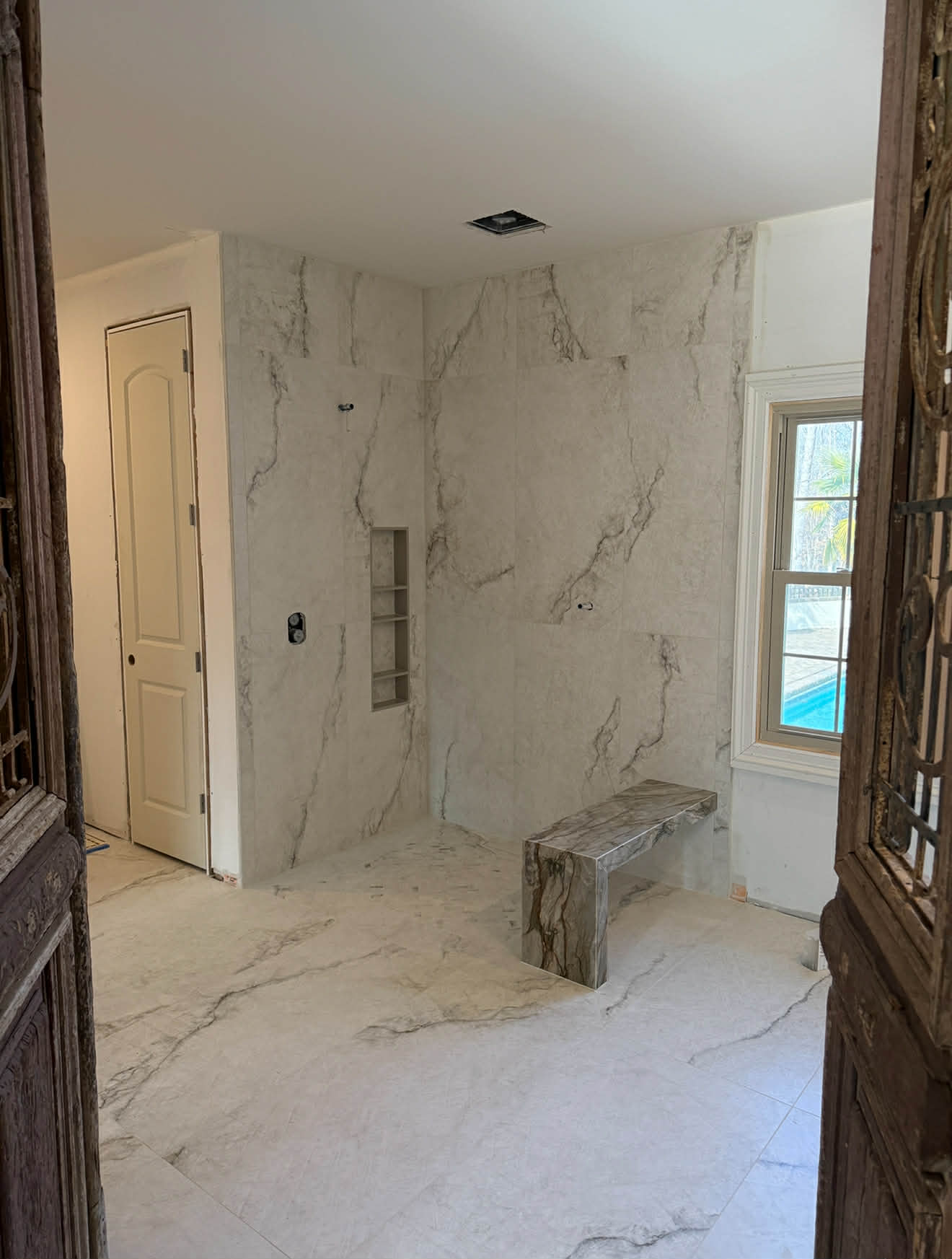 Large format stone tile shower with niche
