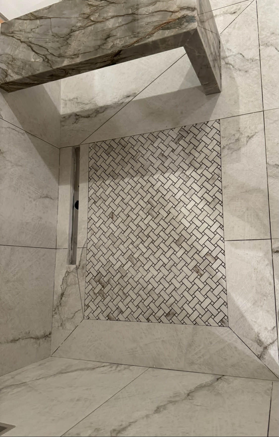 Marble niche detail with herringbone and bench
