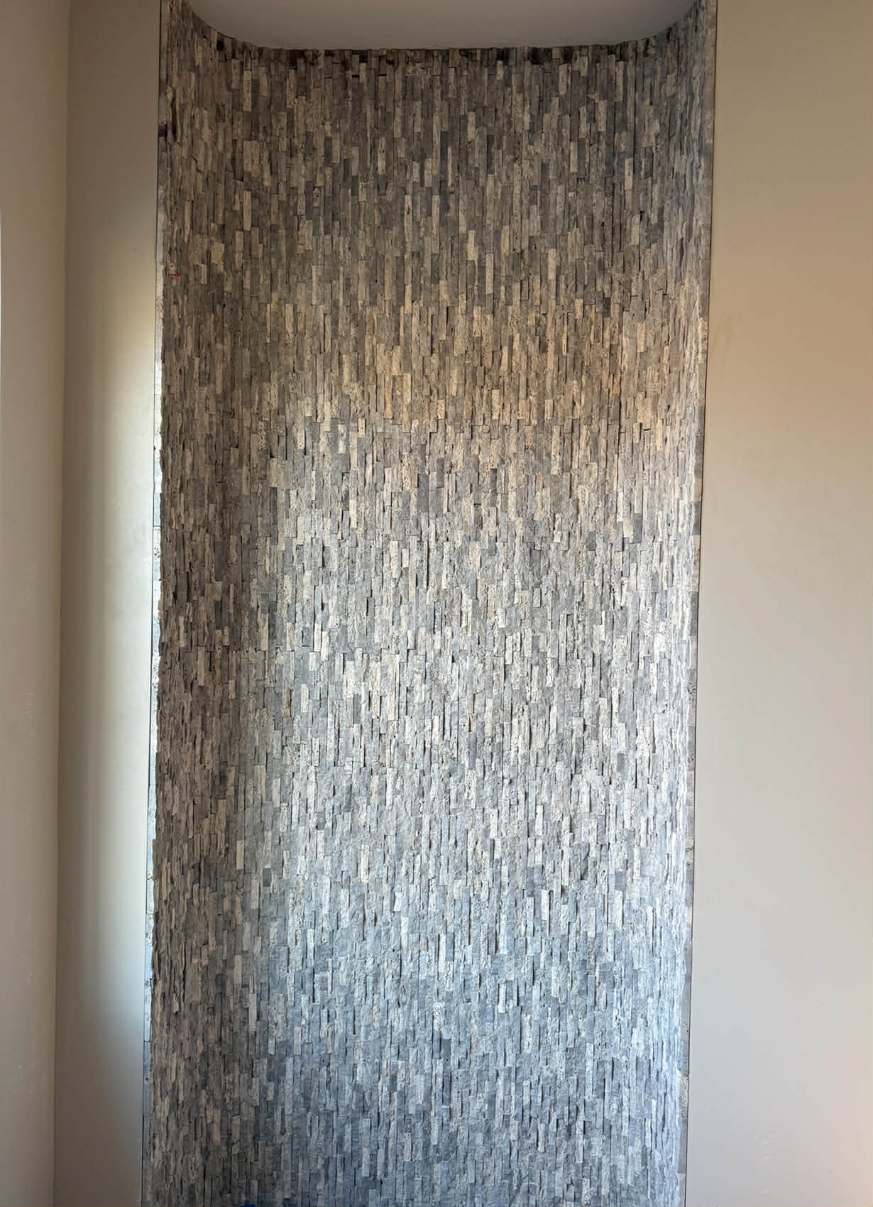 Curved stone mosaic niche feature