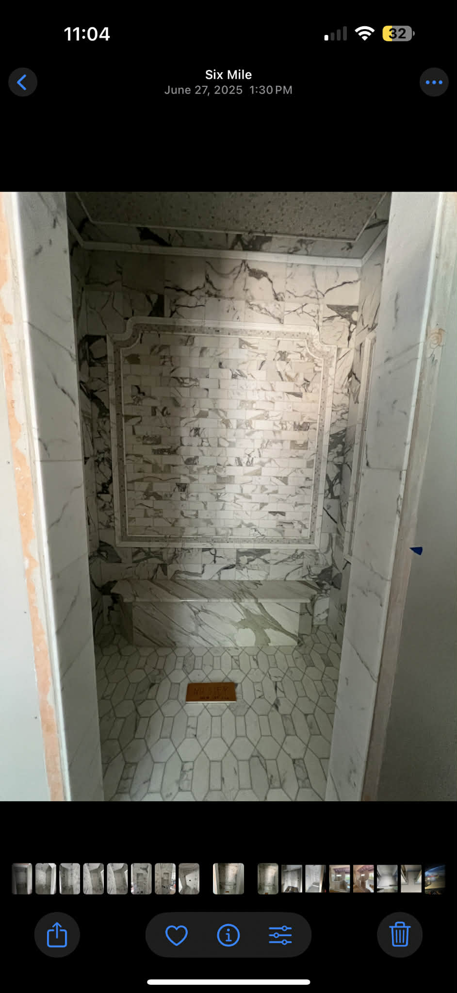 Calacatta steam shower with mosaic border