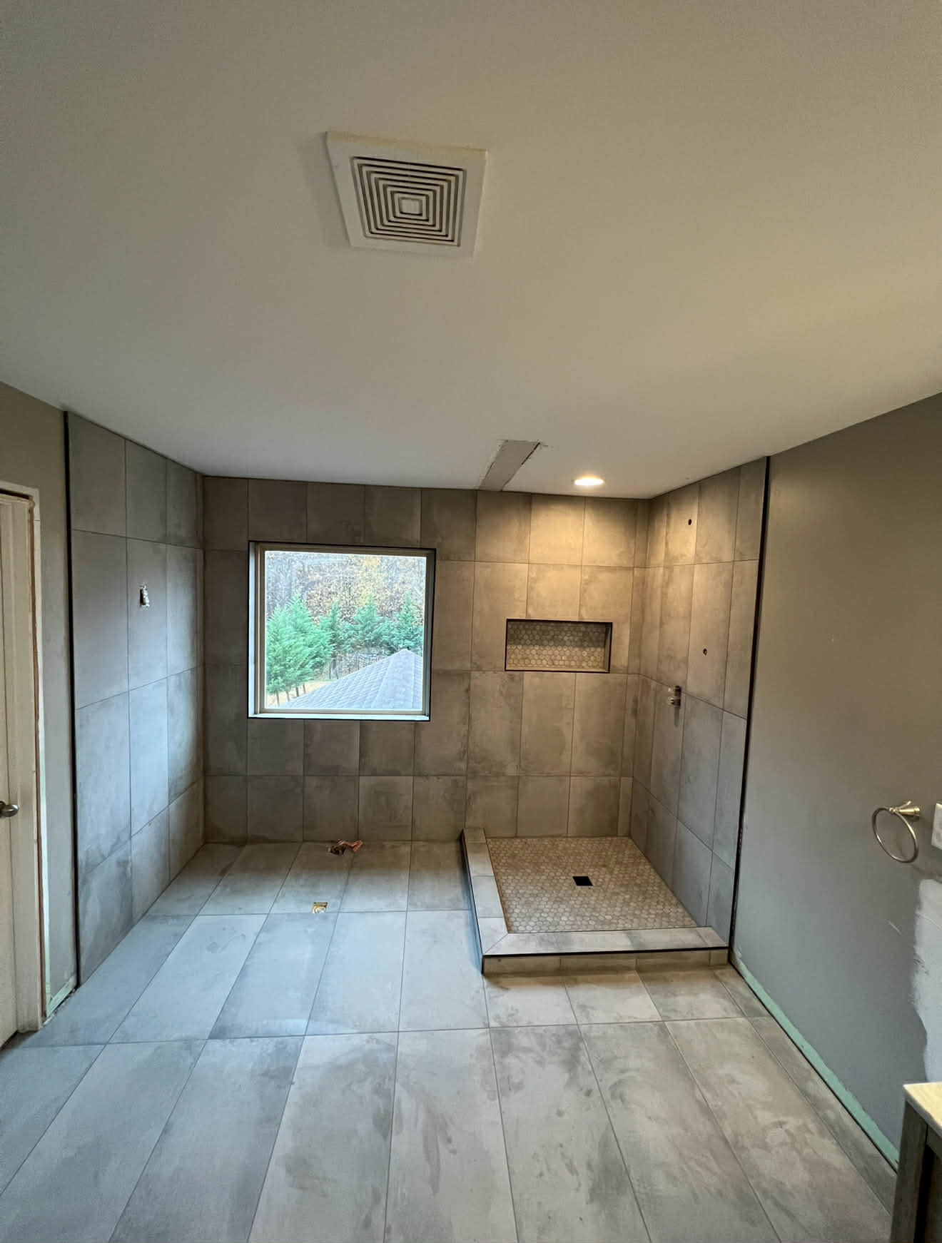 Marble shower with bench and mosaic niche under construction
