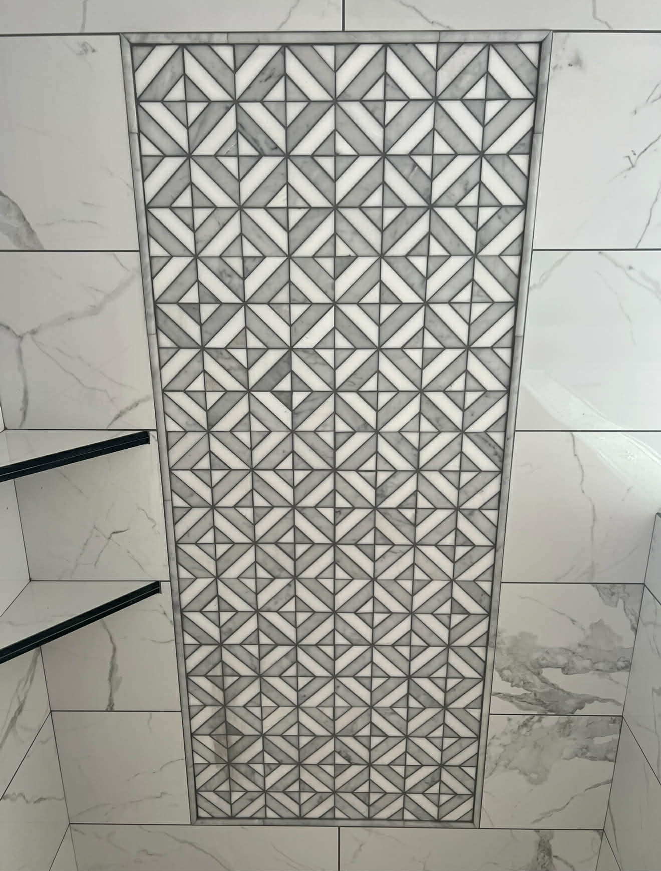 Shower with mosaic tile backsplash